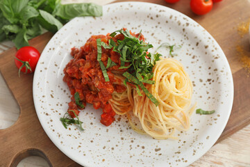 Plate with tasty pasta bolognese on table, closeup