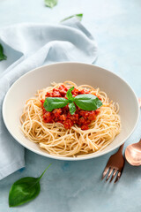 Plate with tasty pasta bolognese on color background