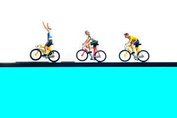 Bike cycling trainer and tracing app. A cycling above smartphone. Miniature people figure conceptual photography.