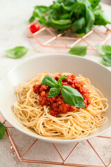 Plate with tasty pasta bolognese on table