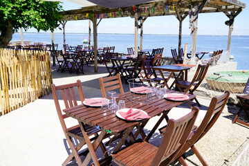 wooden table on beach terrace for seafood oysters tasting on l'herbe village in Cap Ferret at bay Arcachon basin France