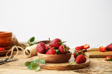 Plate with fresh ripe strawberry on wooden table