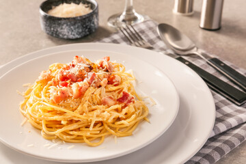 Plate with tasty pasta carbonara on table, closeup