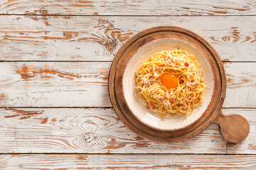 Plate with tasty pasta carbonara on table