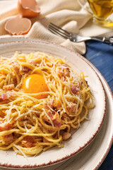 Plate with tasty pasta carbonara on table