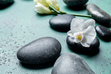 Obraz na płótnie Canvas Spa stones and flower on color background