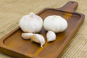 Raw garlic on wood table background