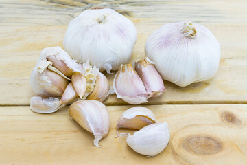 Raw garlic on wood table background