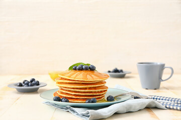 Sweet pancakes with berries on table