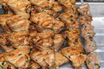 Toasted skewered chicken wings. Dill, spices. Concept - barbecue on chicken meat.