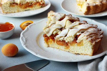 Slice of homemade apricot pie on a plate close up