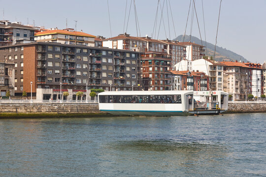 Bizkaia red iron hanging bridge and Nervion river. Euskadi