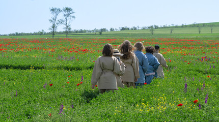 Young women in the poppies field