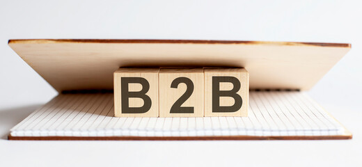 Innovation word wood block B2B on table for business concept.