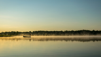 Foggy weather early in the morning on the lake. beautiful wallpapers. a mystical mist vibrates in the lake. summer sunrise