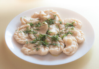 Vareniks (boiled dough) with cheese and green fennel