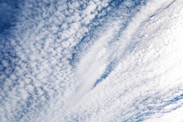 Bright blue sky in the clouds on a clear sunny day. Space for text. Background.