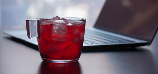 red tea cup with computer