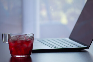 red tea cup with computer