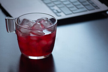 red tea cup with computer