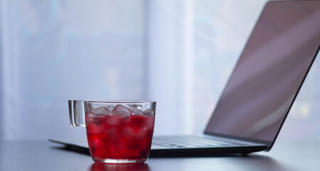 red tea cup with computer