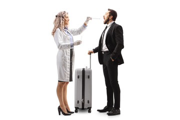 Female doctor with a mask taking a cotton swab sample from a man with a suitcase