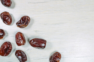 Dried dates on bleached wood, dried fruits.