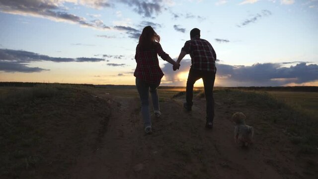 Teamwork. A happy family at sunset on the way to success. Healthy lifestyle, travel. Concept of freedom.