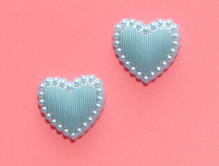 Blue hearts on a pink background.