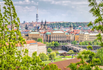 Fototapeta na wymiar Summer sunny landscape of Prague. Ancient architecture and the Vltava river