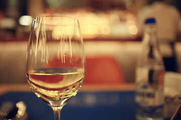glass white wine restaurant interior, abstract evening dinner with alcohol at the bar
