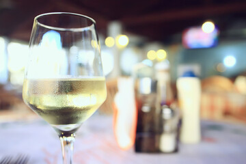 glass white wine restaurant interior, abstract evening dinner with alcohol at the bar