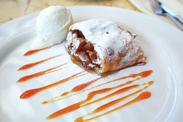 Austrian strudel with ice cream in a cafe, dessert in a restaurant background