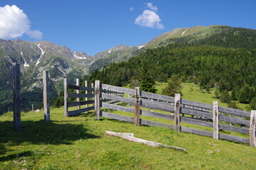 Fototapeta na wymiar Clôtures cortal en bois en montagne pour garder les vaches dans les pâturages dans les Pyrénées à Prat Cabrere face au canigou