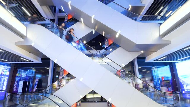 Time lapse escalators in modern shopping mall crowd of people. Very busy full of clients mall complex. Сonsumption concept.