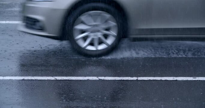 Car tire closeup on wet asphalt road