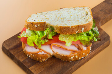 Sandwich of tomato, lettuce and smoked turkey
