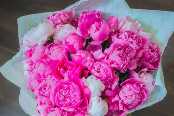 Colorful beautiful flowers bouquet - pink peonies at studio, flower shop - close up top view. Floristry, romantic, holiday, birthday, valentine day, wedding, celebration concept