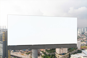 Fototapeta premium Blank white road billboard with KL cityscape background at day time. Street advertising poster, mock up, 3D rendering. Front view. The concept of marketing communication to promote or sell idea.