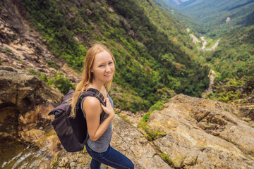 Woman hiker on a rock. View of the valley from the cliff, Vietnam, Da Lat