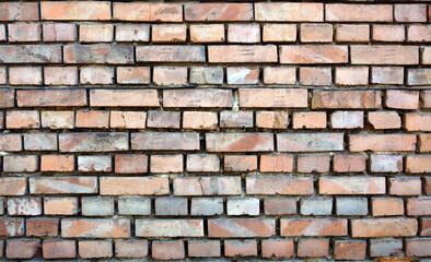texture of old brick wall without  mortar in gaps between bricks.