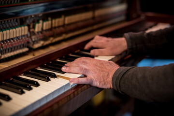 Obraz na płótnie Canvas Music. Musician plays vintage piano. Hands closeup.