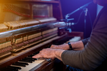 Music. Musician plays vintage piano. Hands closeup.
