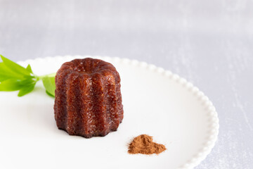 Canele, French confectionery, on a white and grey background