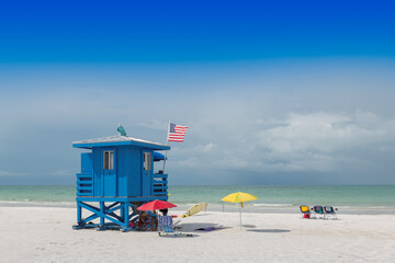 Lifeguard beach house on a beautiful summer day with ocean and blue cloudy sky in Siesta Key Beach, Florida USA