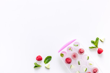 Ice cubes with berries and mint top view copy space