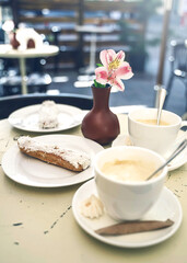 breakfast with coffee and cookie, food on the table in cafe