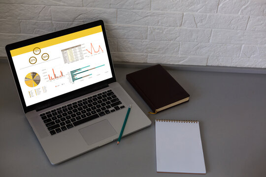 Laptop on table showing charts and graph, Analysis Business Accounting, Statistics Concept.