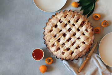Apricot pie in baking dish on the table top view