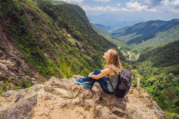 Fototapeta premium Woman hiker on a rock. View of the valley from the cliff, Vietnam, Da Lat